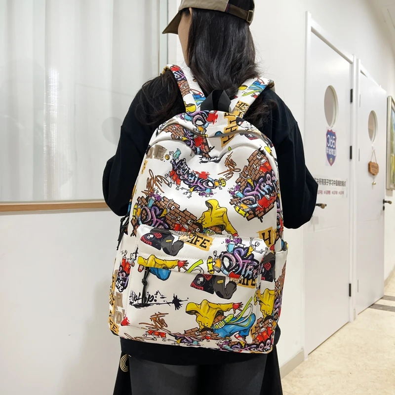 新款涂鸦双肩包男大容量大学生书包女潮酷初中高中学生背包